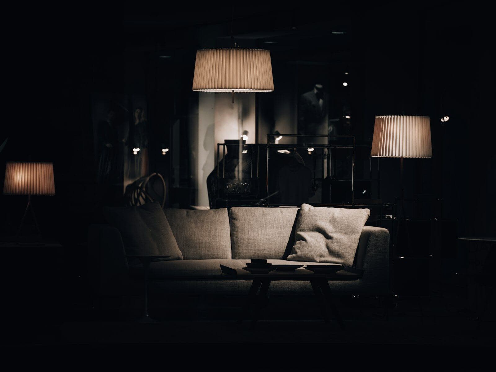 Living room in near darkness, lit by two shaded lamps